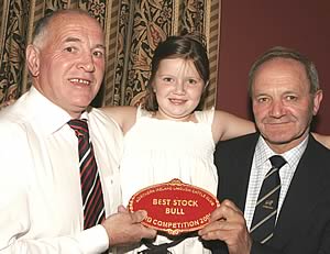 Herbie Crawford, Stephen Crawford and herd competition Mr David Rakin receiving award for Best Large Herd in Northern Ireland
