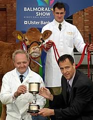 herbie crawford being presented with the junior female champion trophy from cormac mckervey from the ulster bank with stephen holding the junior champion