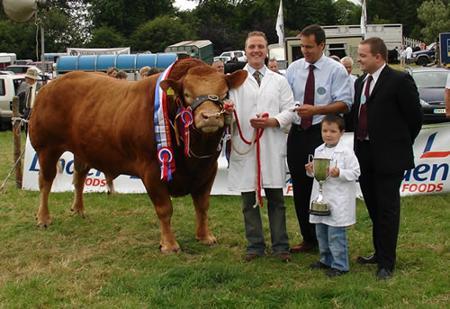 Raymond Crawford with nephew Martin Rodgers being presented with the Champion Limousin cup. 